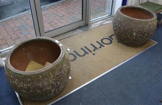 A pair of large lava effect garden pots W.70cm approx.